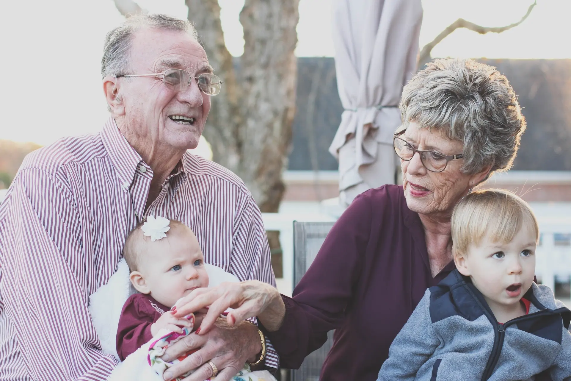 Grandparents sitting with their grandchildren on their laps